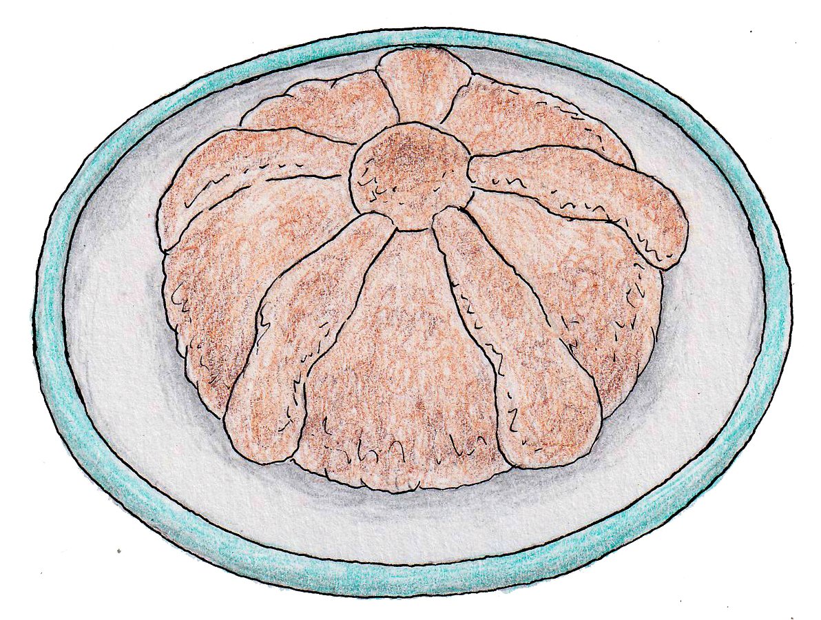 A round loaf of pan de muerto on a white plate with a teal rim.